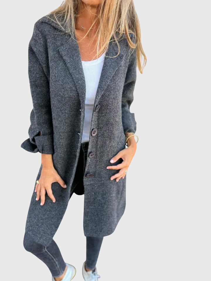 Women's button-detail blazer styled over a blouse, ideal for office wear, professional settings & stylish looks.