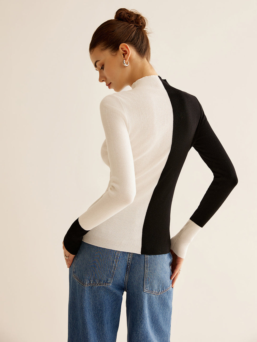 Trendy women's pullover sweater with elegant color block, great for casual or dressed-up looks.