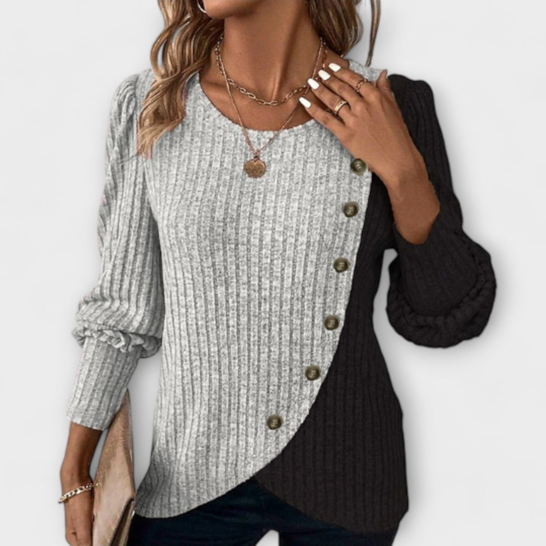 Chic women's colorblock blouse with stylish asymmetric hem, perfect for versatile office or casual wear. Long sleeve top.