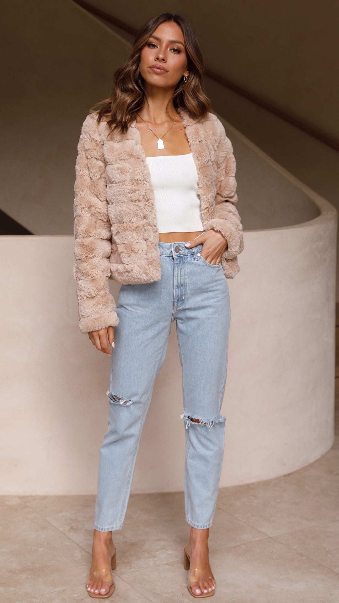 Elegant striped cropped jacket for women. Chic outerwear for a sophisticated look.