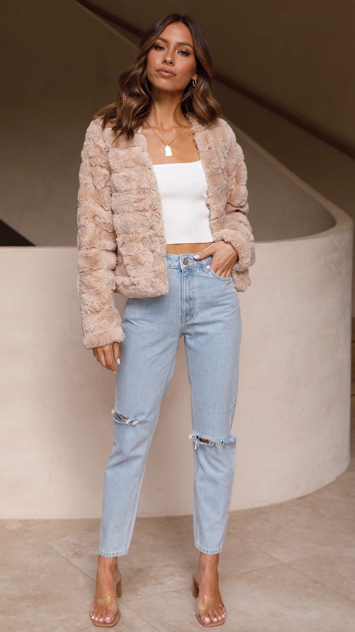 Elegant striped cropped jacket for women. Chic outerwear for a sophisticated look.
