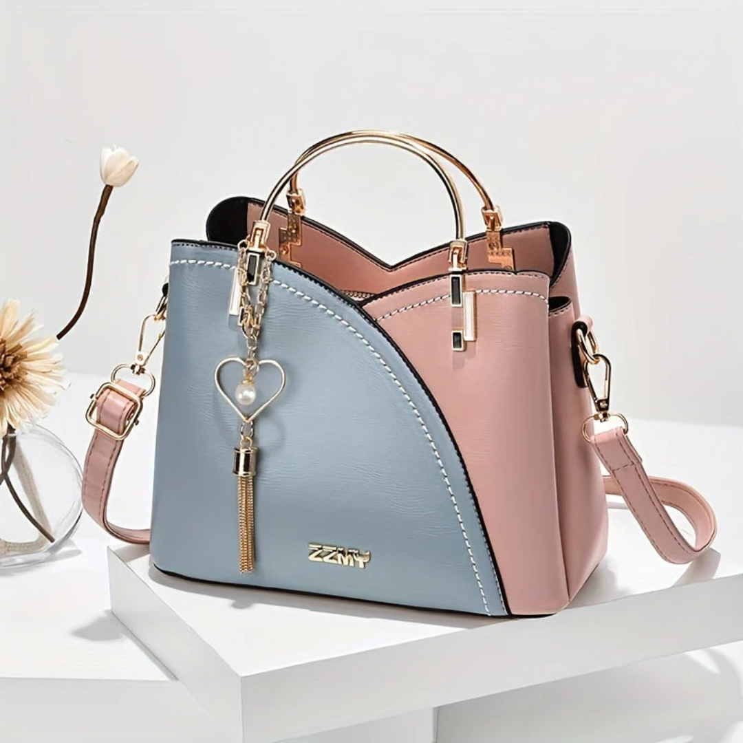 Crossbody style women's faux leather handbag. Chic versatile everyday shoulder bag.