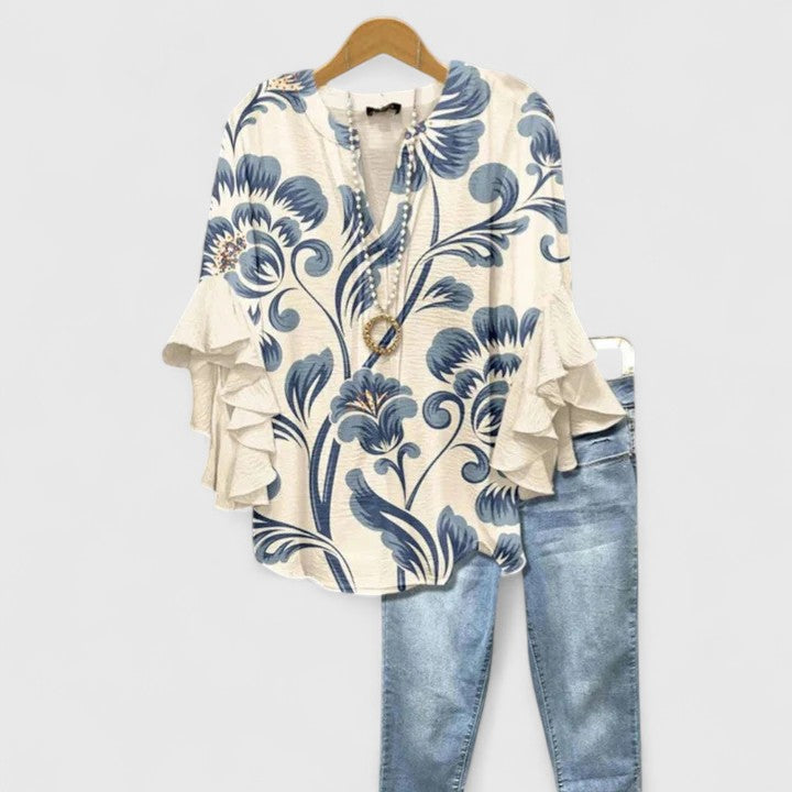 Chic women's floral blouse with elegant ruffled sleeves. Versatile long-sleeve top for casual or formal wear.
