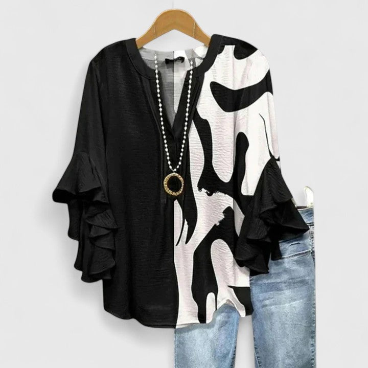 Women's long-sleeve floral blouse featuring chic ruffles. An elegant and versatile top for various outfits.