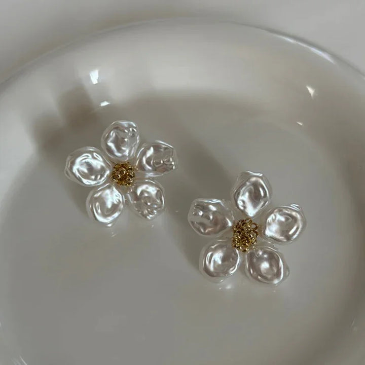 Artistic statement earrings: women's irregular pearl petal design. Unique, chic, and modern fashion jewelry.