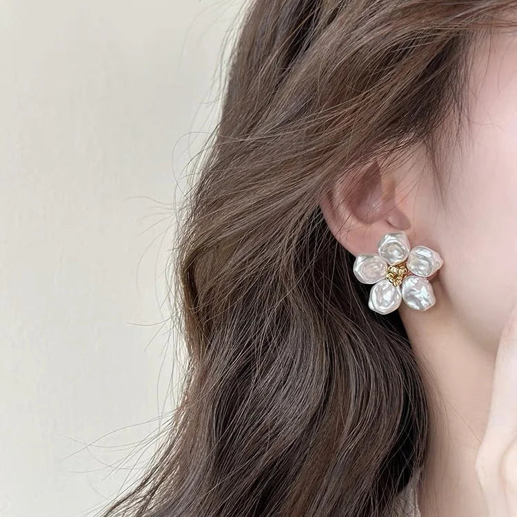 Stylish women's irregular pearl petal earrings. Modern fashion jewelry with a unique, artistic flair.