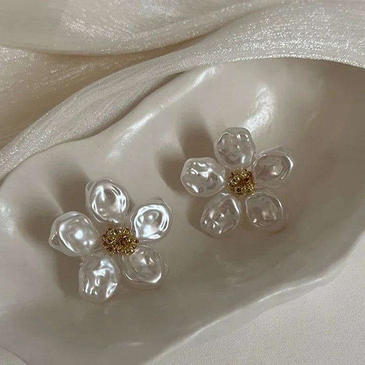 Delicate irregular pearl petal earrings for women. Unique design with lustrous pearls, a chic fashion accessory.