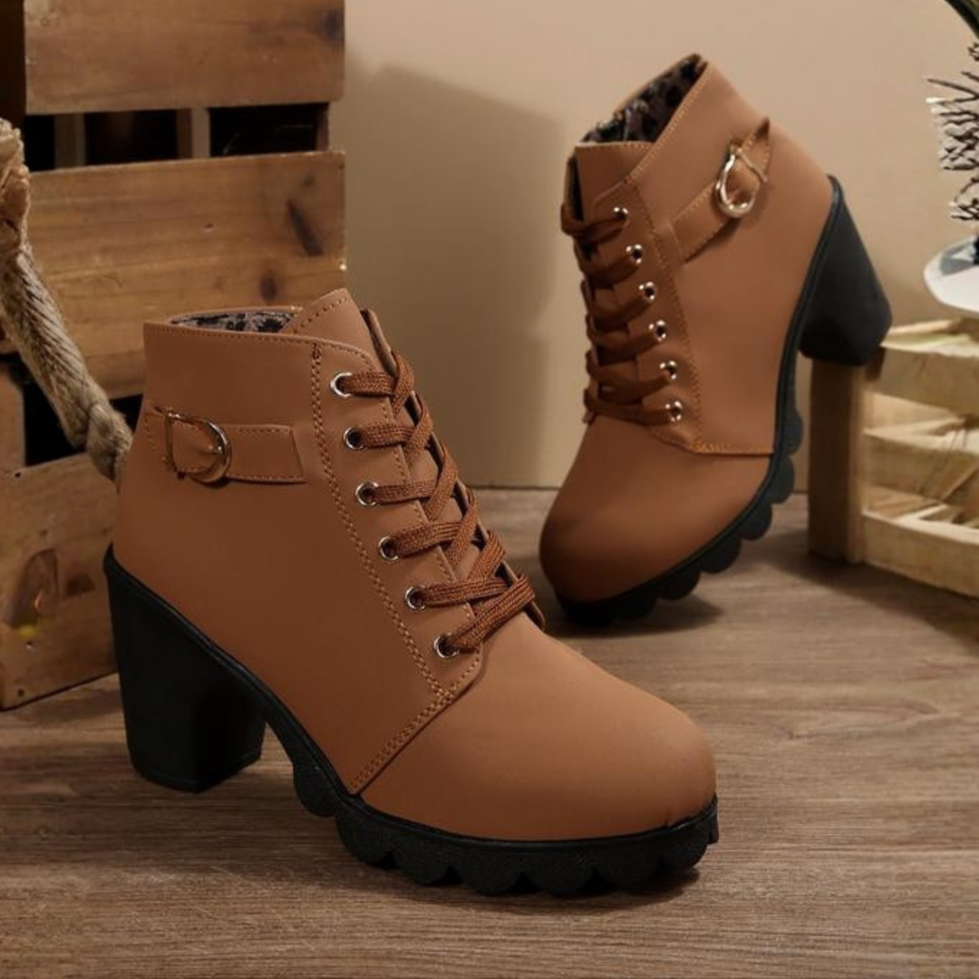 Stylish women's black lace-up chunky ankle boots. Versatile heeled boots for comfort and fashion.