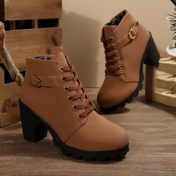 Stylish women's black lace-up chunky ankle boots. Versatile heeled boots for comfort and fashion.