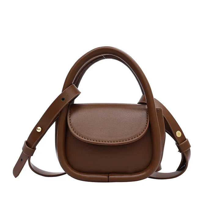 Small genuine leather shoulder bag for women, featuring a secure snap closure.