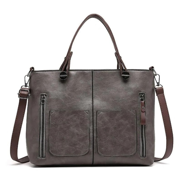 Stylish brown leather shoulder bag for women, versatile tote with secure zippered pockets.