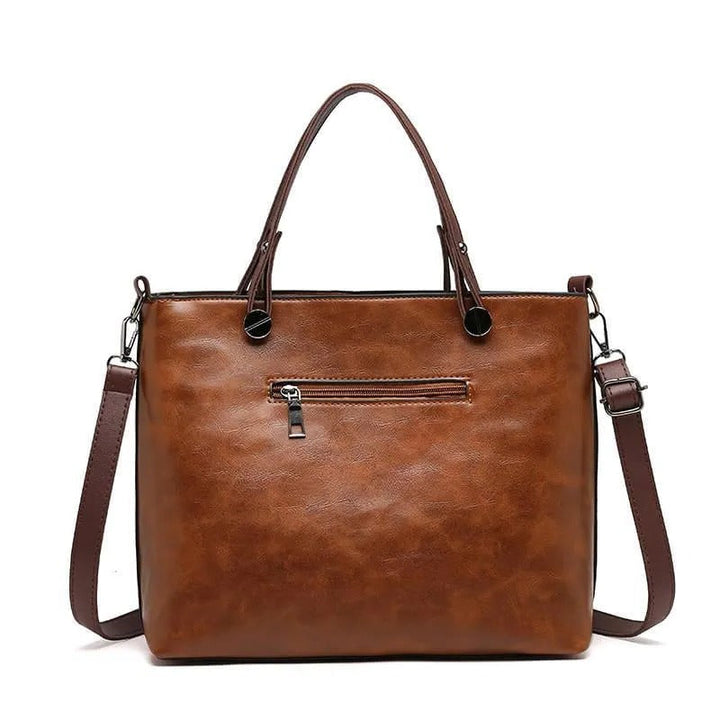 Versatile gray leather handbag with chic design & convenient zippered pockets for daily use.
