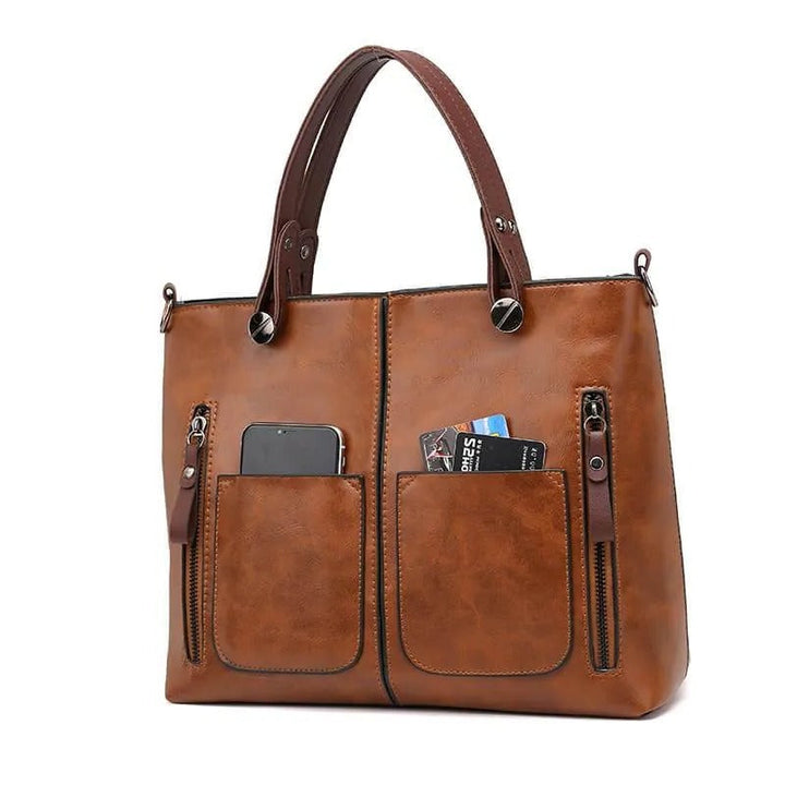 Fashionable women's leather tote bag, highly organized with zippered pockets, ideal for style & function.
