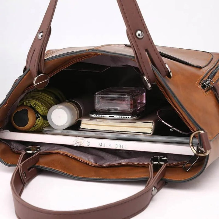 Sophisticated women's leather handbag; a stylish shoulder bag with secure zippered pockets for daily essentials.