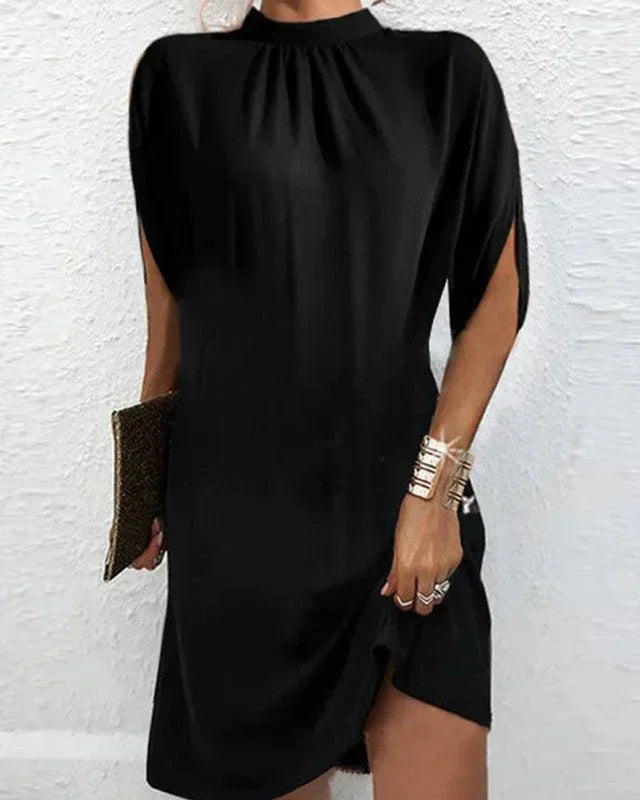 Elegant women's short dress featuring a mock neck, unique split cape sleeves, & chic asymmetric hem.