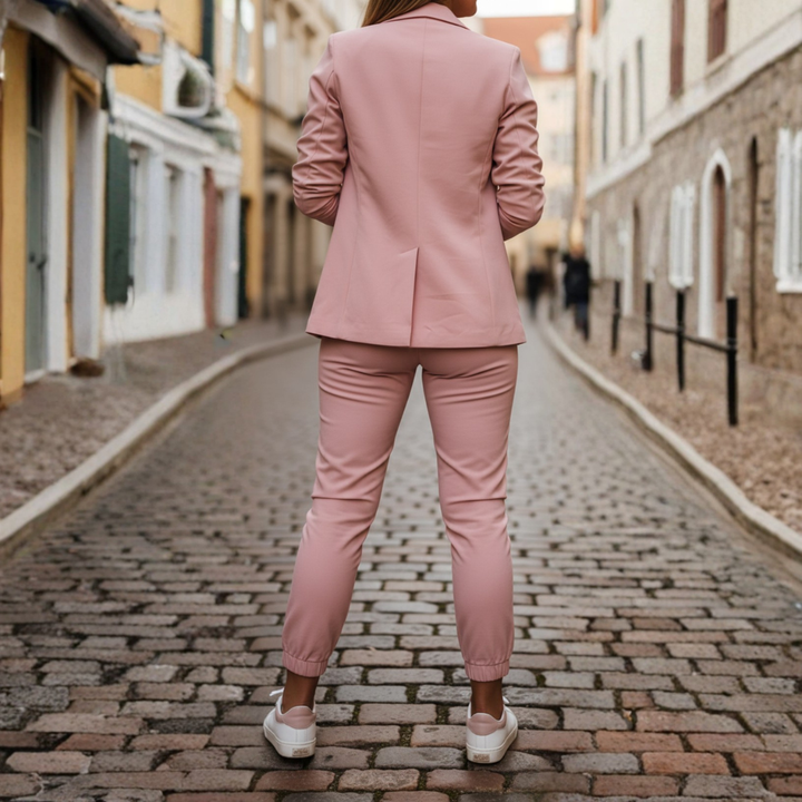 Pink women's two-piece blazer and jogger set. Features an open front blazer & comfortable ruched sleeve joggers.