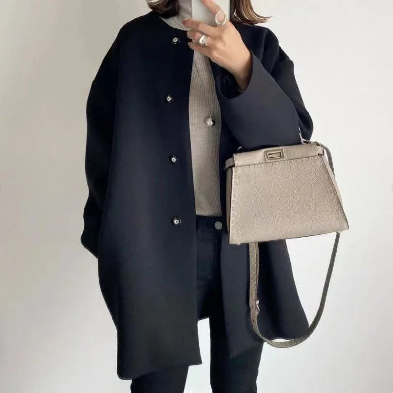 Elegant women's oversized button coat for minimalist fashion. A chic long coat for office wear or streetwear.