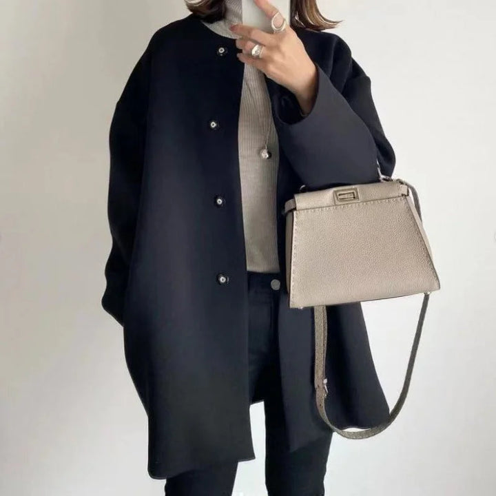 Elegant women's oversized button coat for minimalist fashion. A chic long coat for office wear or streetwear.