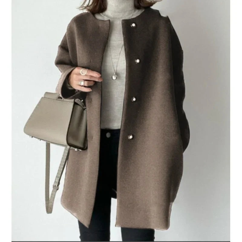 Effortless style with this women's oversized button coat. A chic, versatile autumn-winter layering piece.