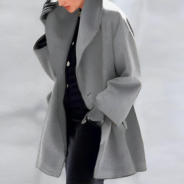 Stylish women's oversized coat. A timeless long fall jacket, ideal for chic layering and sophisticated winter outerwear fashion.