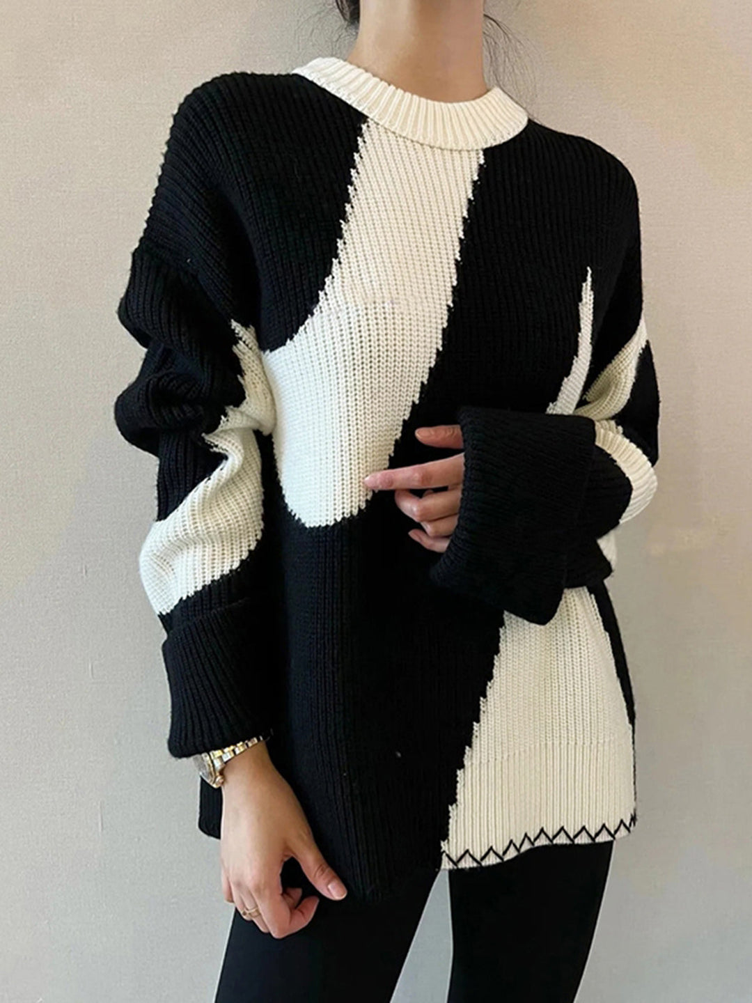 Back view of a trendy women's oversized zebra print long-sleeve sweater, ideal for chic casual wear.