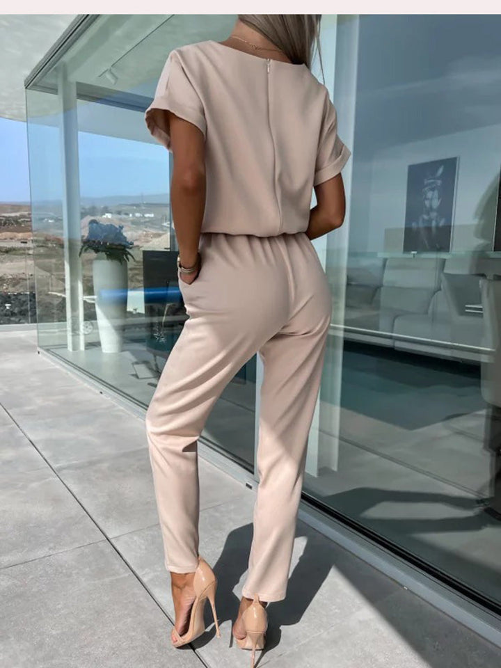 Elegant women's one-piece jumpsuit with short sleeves and a cinched belt, great for summer fashion.