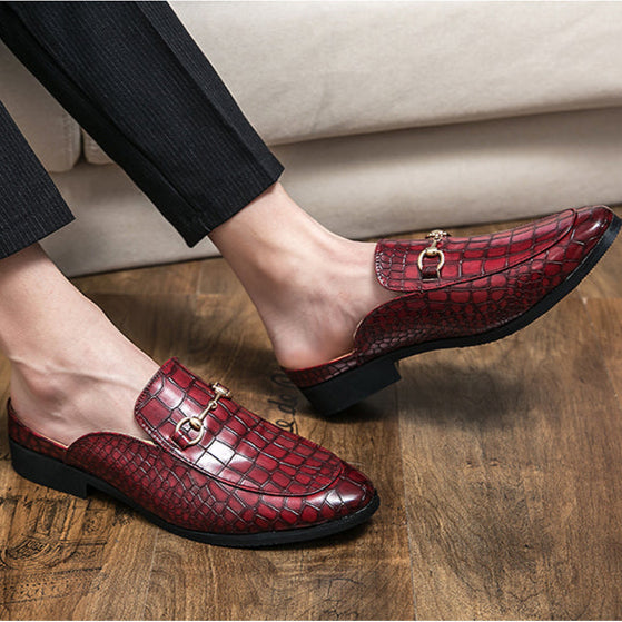 Luxurious black slip-on mules with chic horsebit detail; comfortable women's elegant footwear.