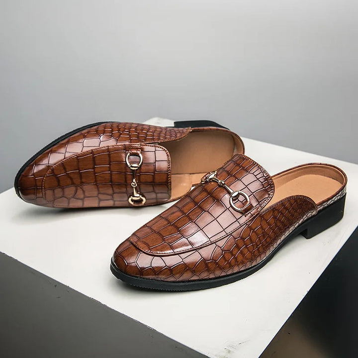 Chic brown slip-on mules featuring elegant horsebit detail; comfortable women's versatile footwear.