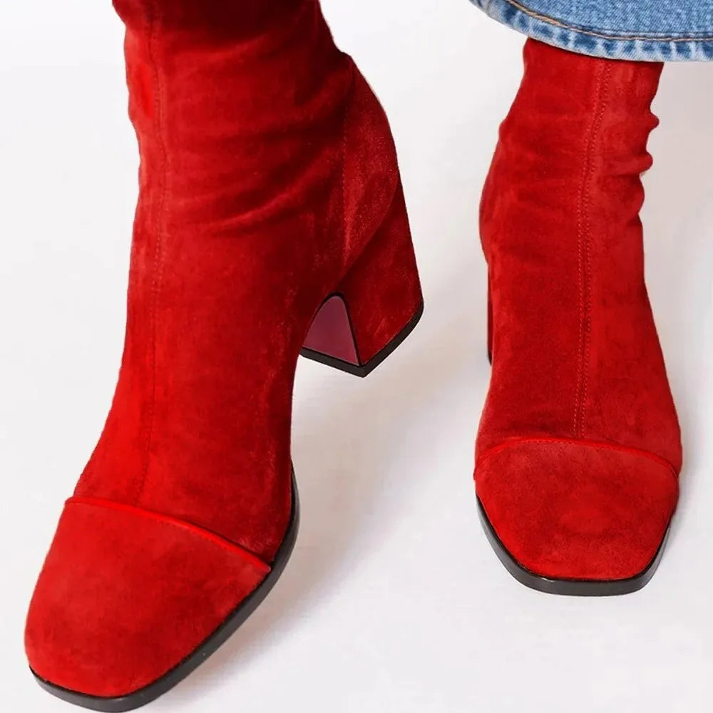 Modern women's black square toe heeled ankle boots. Comfortable block heel, versatile fall fashion.