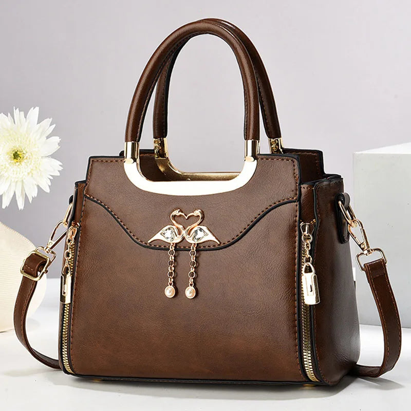 Chic women's structured handbag in black faux leather with a detachable strap, perfect for shoulder or crossbody wear.