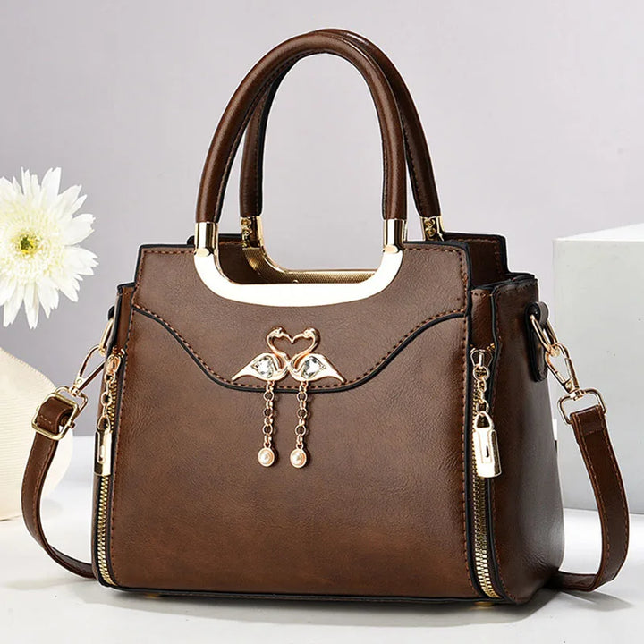 Chic women's structured handbag in black faux leather with a detachable strap, perfect for shoulder or crossbody wear.