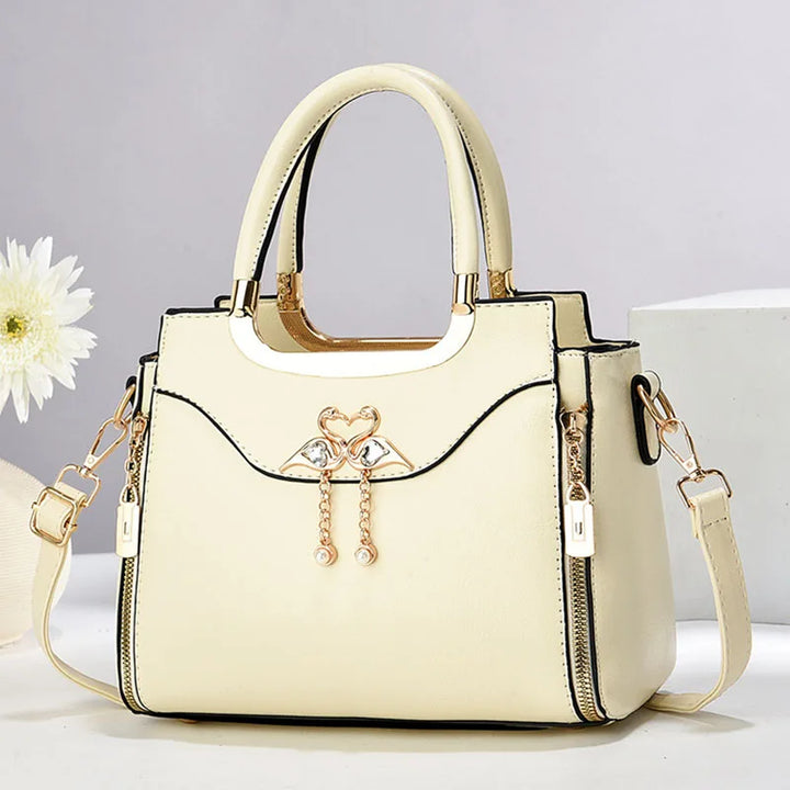 Sophisticated women's structured faux leather handbag. Features a detachable strap for shoulder or crossbody wear.
