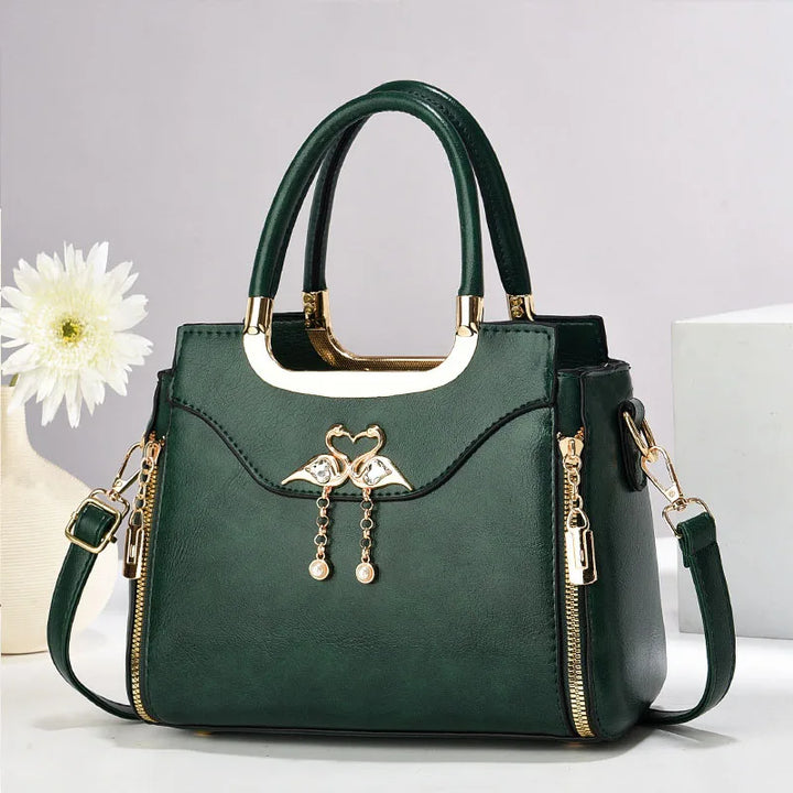 Women's chic structured handbag. This elegant faux leather shoulder bag includes a convenient detachable strap.