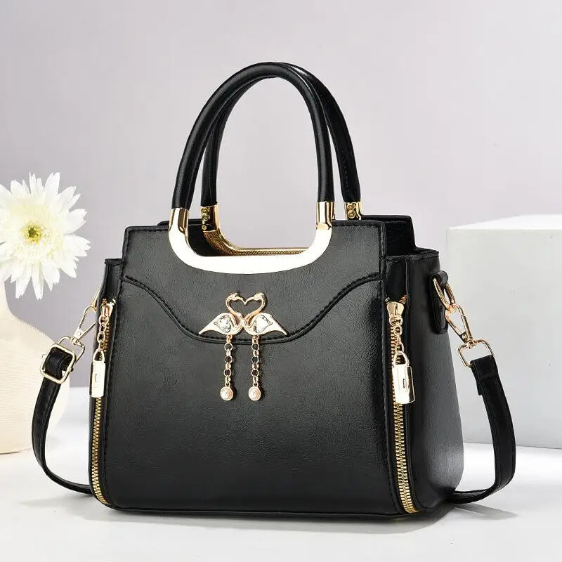 Stylish faux leather structured handbag for women. Functions as a shoulder bag or crossbody bag with its detachable strap.