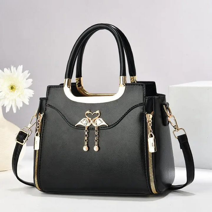 Stylish faux leather structured handbag for women. Functions as a shoulder bag or crossbody bag with its detachable strap.