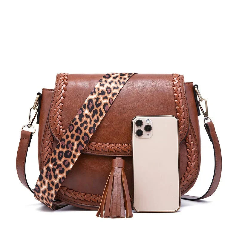 Sophisticated women's shoulder bag: a chic saddle bag design with fringe tassels and spacious interior.