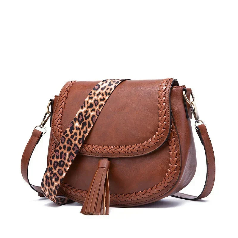 Close-up of the women's tassel saddle bag, highlighting the quality material and fringe details.