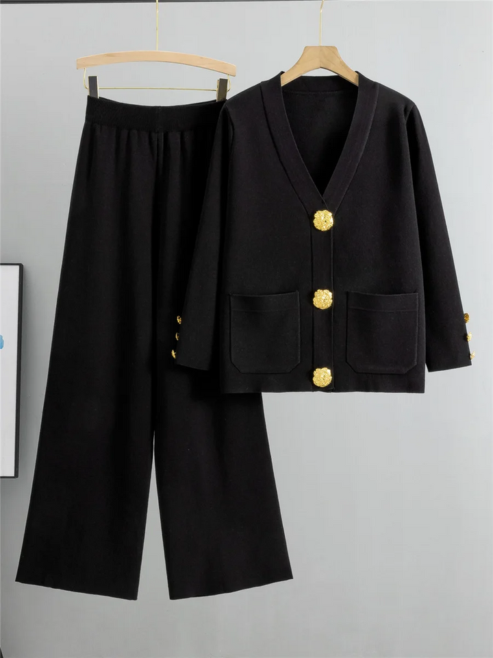 Sophisticated women's gold trim two-piece set, ideal for elegant occasions. Features a stylish top and flowing bottom.