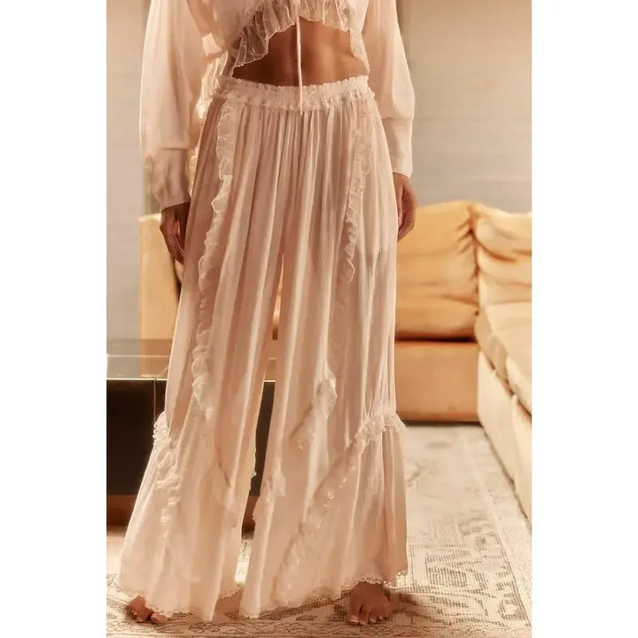 Effortlessly chic women's two-piece lounge set with ruffles. Comfortable cotton blend, wide-leg design for ultimate relaxation.