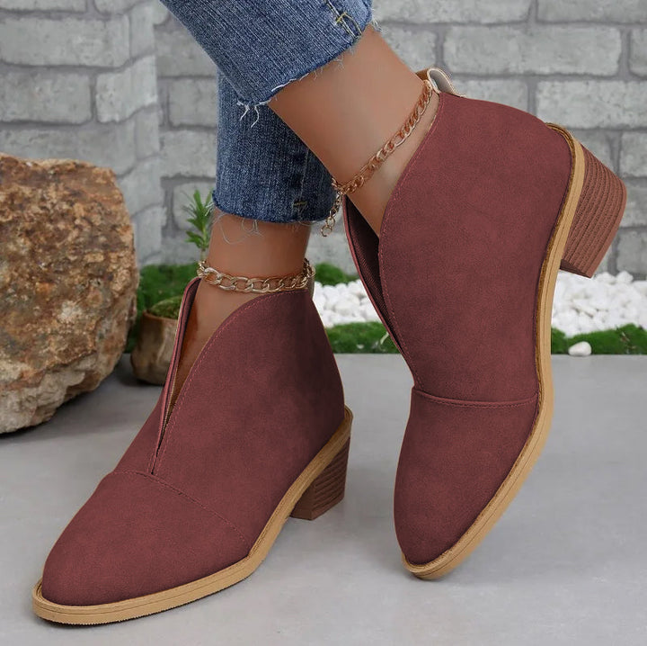 Elegant women's V-cut ankle boots, offering comfortable everyday style. Essential chic footwear for fall/winter.
