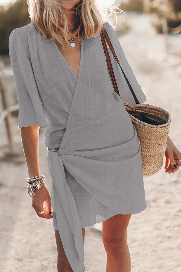 Chic women's V-neck draped mini dress, ideal for summer vacation or casual spring outings. Effortless short sleeve style.