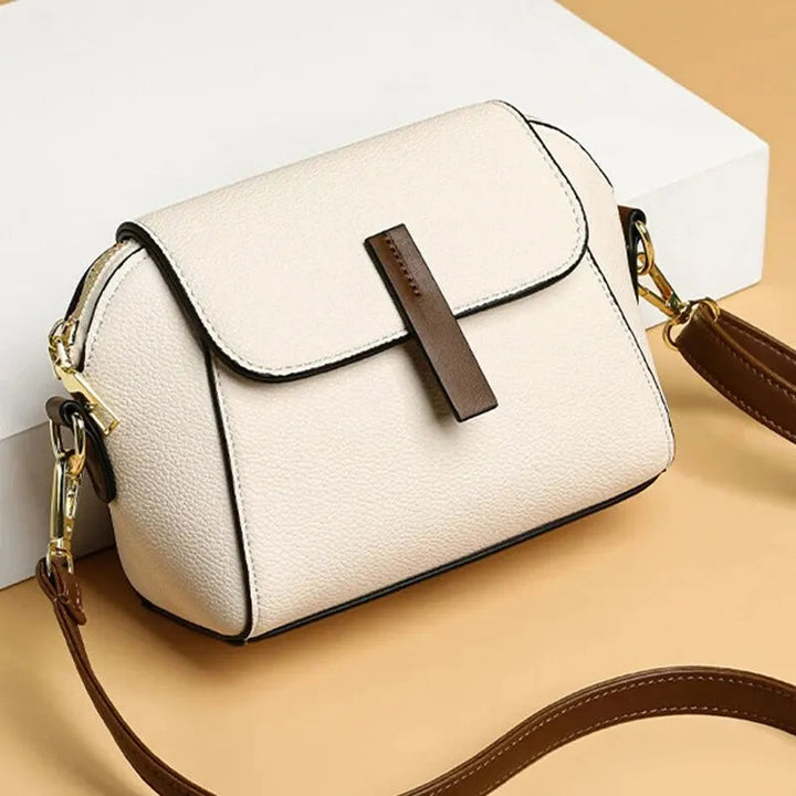 Versatile women's vegan leather mini bag with secure magnetic closure.