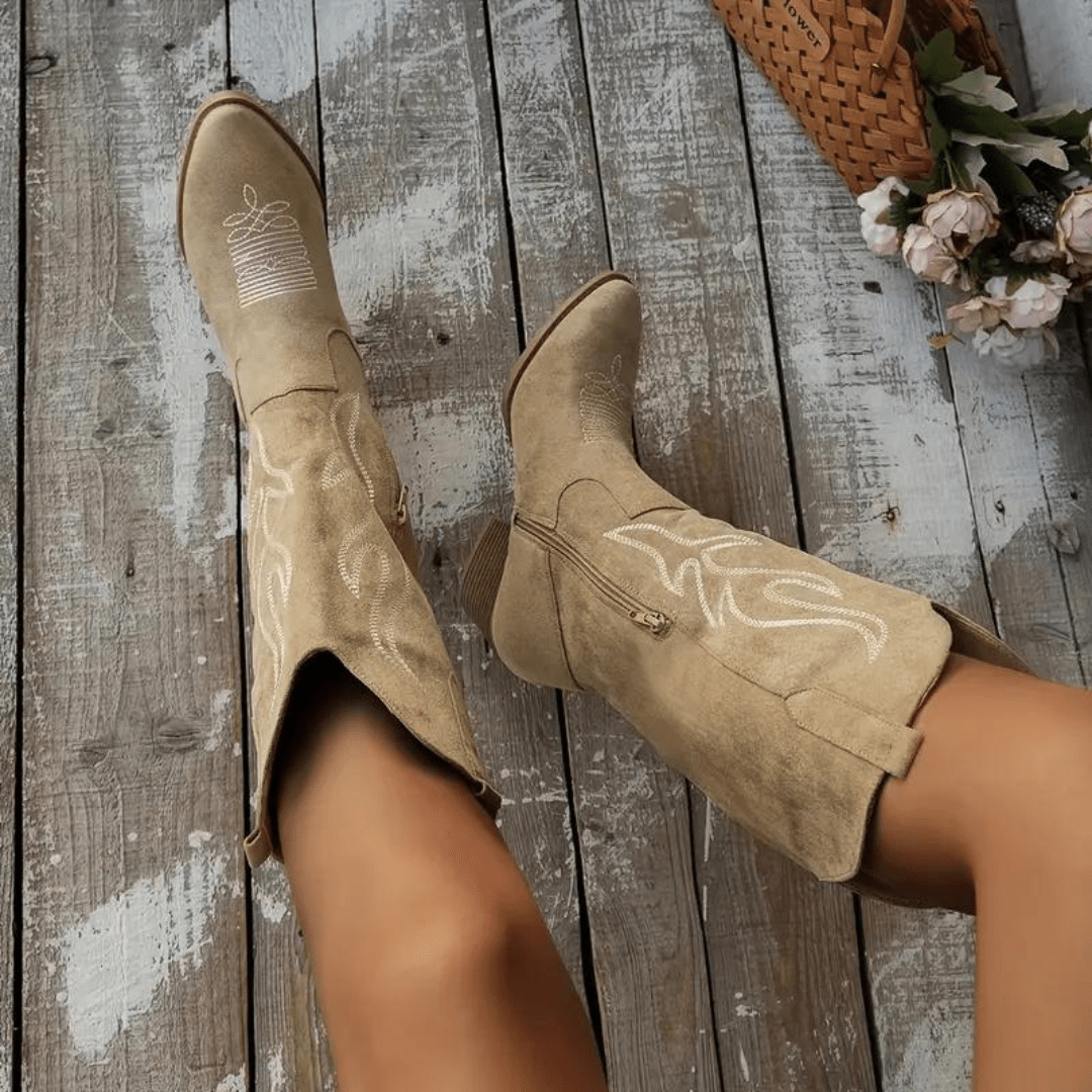 Chic women's Western cowboy boots. Features a convenient side zipper, pointed toe, and elegant embroidered details.