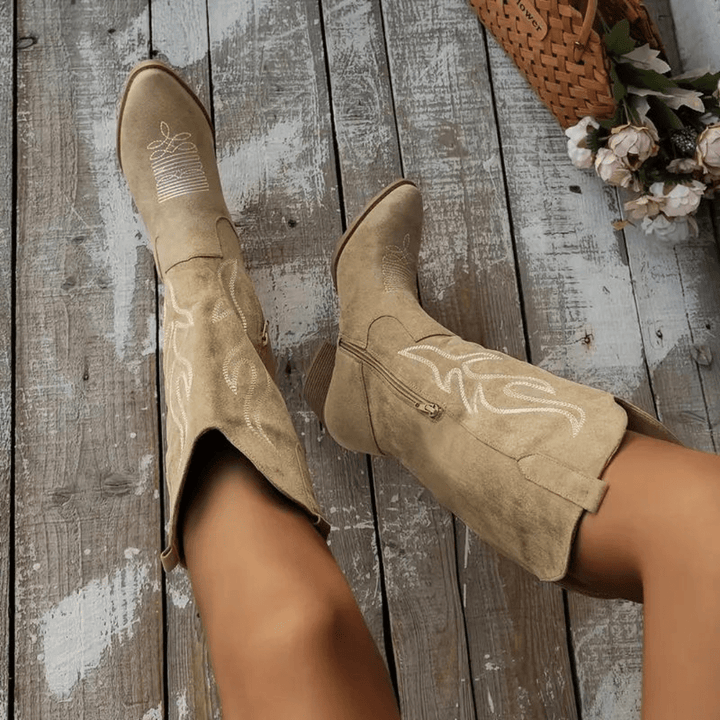 Chic women's Western cowboy boots. Features a convenient side zipper, pointed toe, and elegant embroidered details.