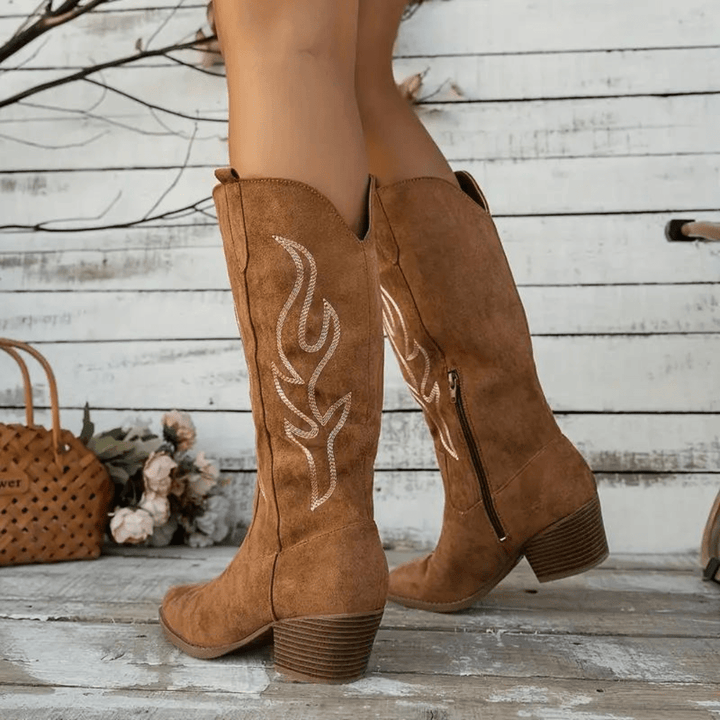 Stylish women's cowboy boots with a pointed toe, intricate Western embroidery, and side zipper for easy wear.