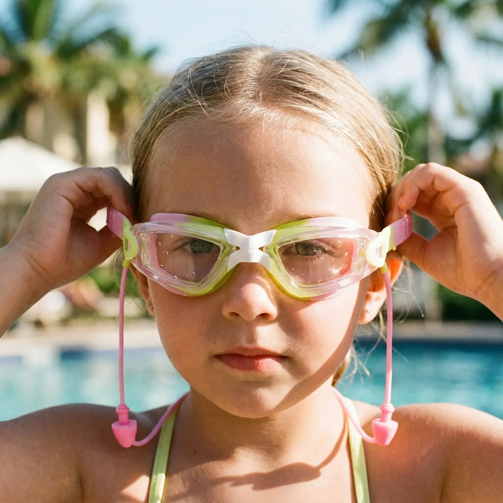 Children's anti-fog swimming goggles with integrated earplugs for comfortable kids swim & clear pool vision.
