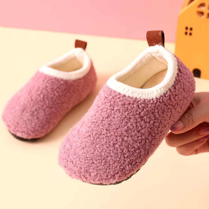 Kids SnuggleSteps cozy slippers, ultimate warmth & softness for home wear. Non-slip design.