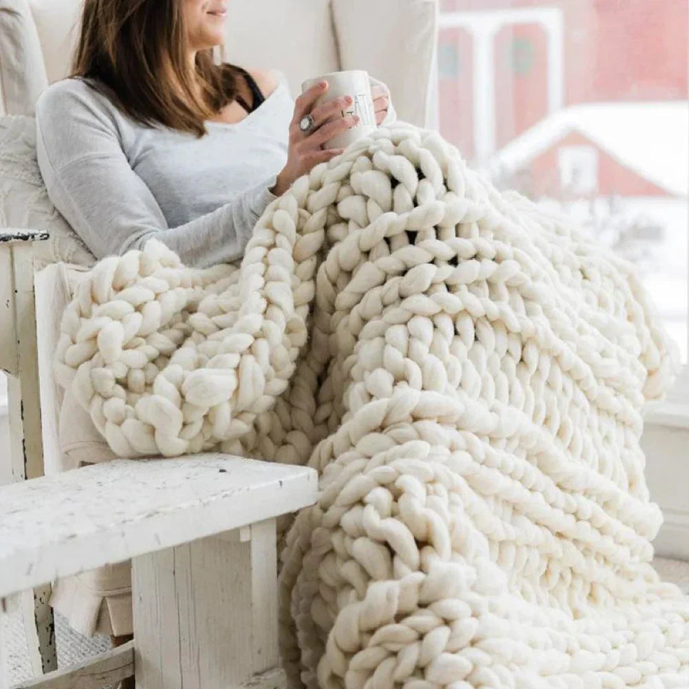 Spool of thick, luxurious chunky wool yarn for knitting and home decor.