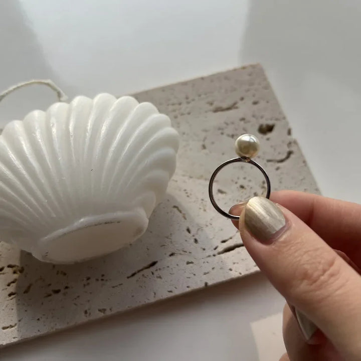 Elegant women's adjustable pearl ring with a lustrous freshwater pearl on a sterling silver band.
