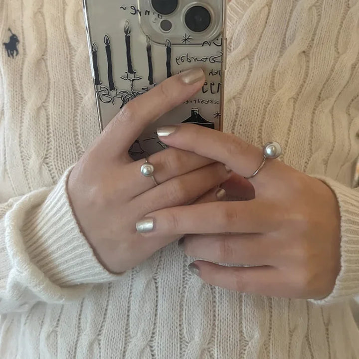 Close-up of a classic adjustable sterling silver pearl ring with a round freshwater pearl.